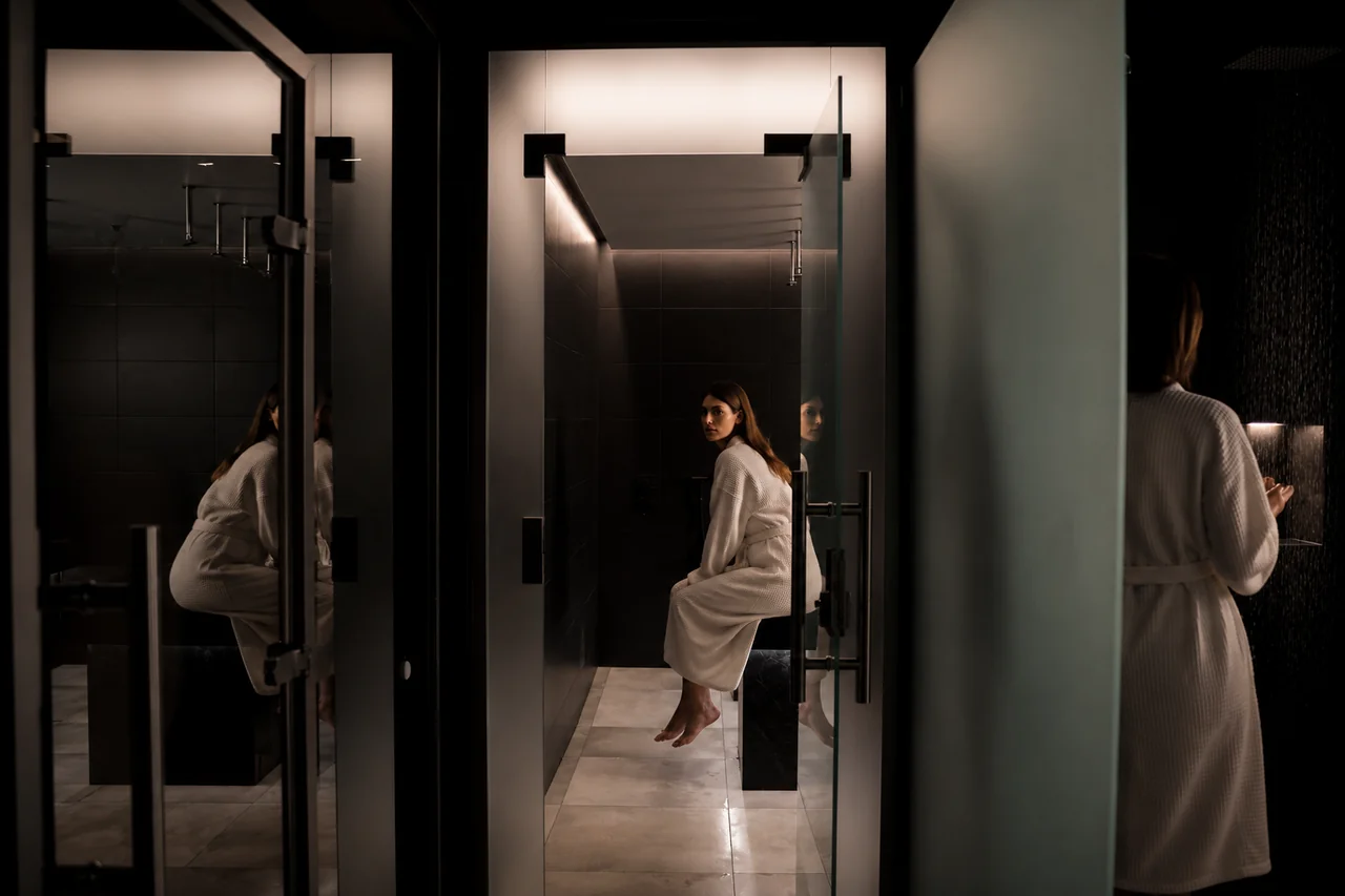 Serene Nordic spa atmosphere with soft lighting and water reflections